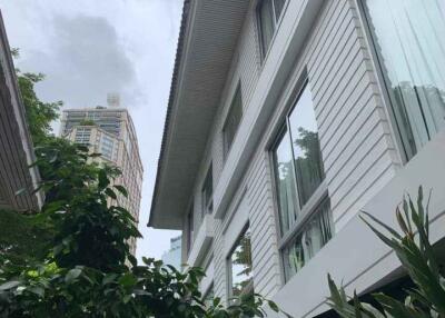 Exterior view of a building with large windows and plants