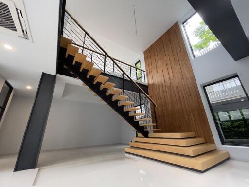 Modern open staircase with wooden steps and metal railings