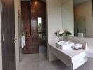 Modern bathroom with tiled shower and large mirror