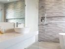 Modern bathroom with a vessel sink, glass shower, and wave-patterned wall tiles