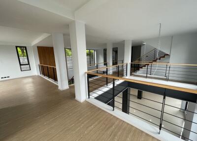 Modern open-plan interior with railing and large windows