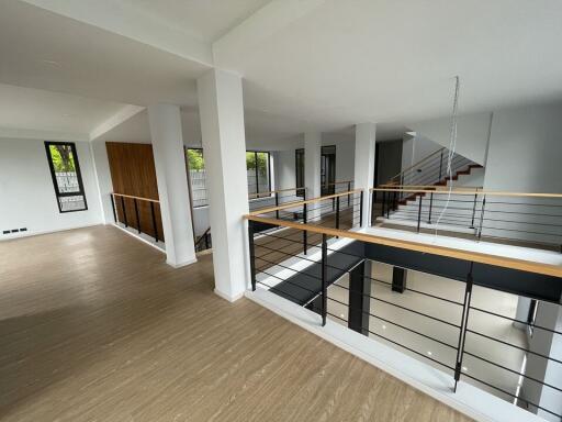 Modern open-plan interior with railing and large windows