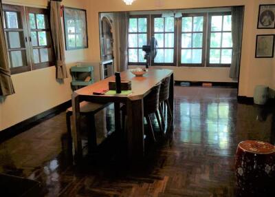 Spacious dining room with large windows and chandelier