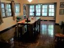 Spacious dining room with large windows and chandelier