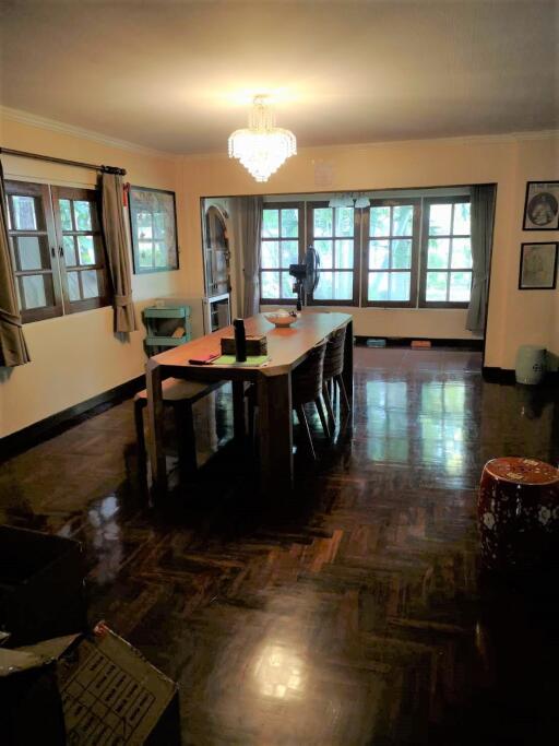 Spacious dining room with large windows and chandelier