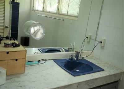 Bathroom with marble countertop and blue sink