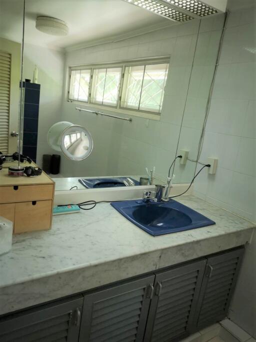 Bathroom with marble countertop and blue sink