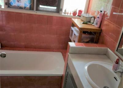 Bathroom with red tiles and a sink