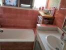 Bathroom with red tiles and a sink