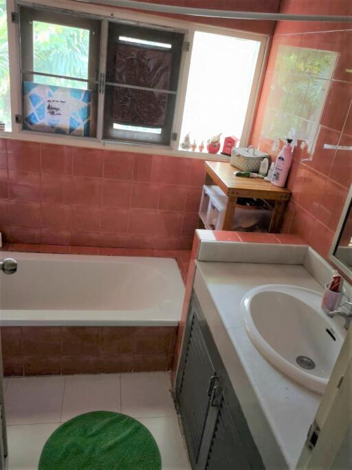 Bathroom with red tiles and a sink