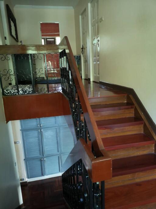 Wooden staircase with decorative railing in a residential home