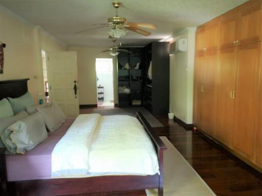 Spacious bedroom with wooden furniture and ample storage