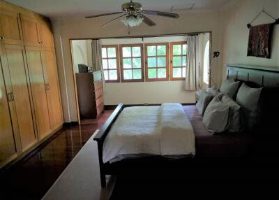 Spacious bedroom with large windows and ample storage