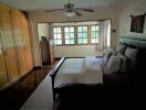 Spacious bedroom with large windows and ample storage