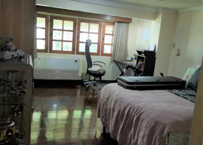 Bedroom with office space and wooden floor