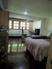 Bedroom with office space and wooden floor