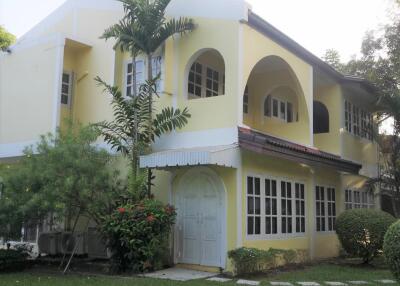 Exterior view of a two-story house with a garden