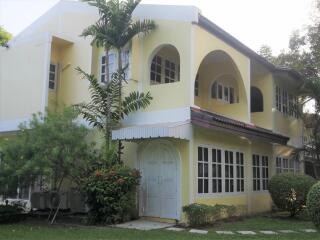 Exterior view of a two-story house with a garden