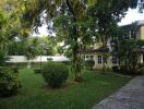 Spacious garden with lush greenery and a view of the house