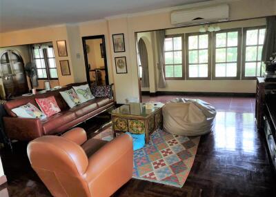 Spacious living room with leather furniture and large windows