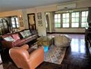 Spacious living room with leather furniture and large windows