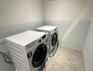 Laundry room with washing machines and air conditioner