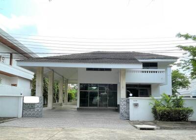 Front view of a two-story house with a driveway and greenery