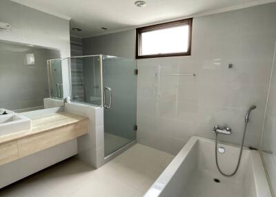 Modern bathroom with bathtub, shower, and vanity