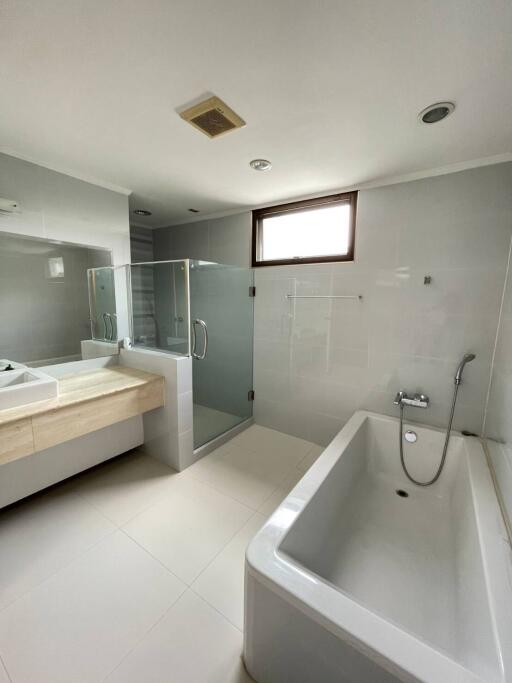 Modern bathroom with bathtub, shower, and vanity