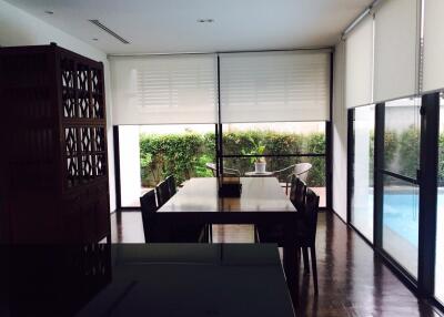 Modern dining area with large windows and pool view