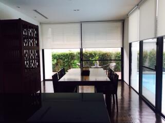 Modern dining area with large windows and pool view