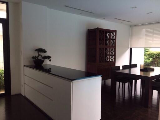 Modern dining room with wooden table and cabinet