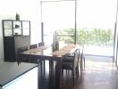 Modern dining room with large windows and simple decor