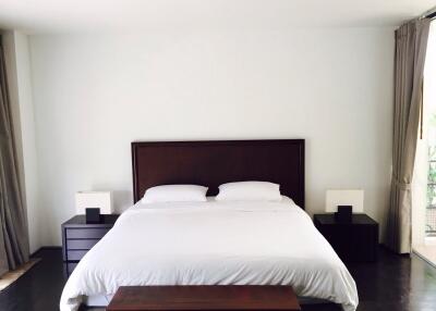 Modern bedroom with white bedding and minimalistic decor