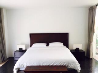 Modern bedroom with white bedding and minimalistic decor