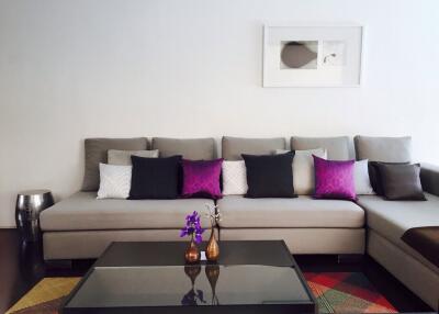 Modern living room with a sectional sofa and colorful decorative pillows