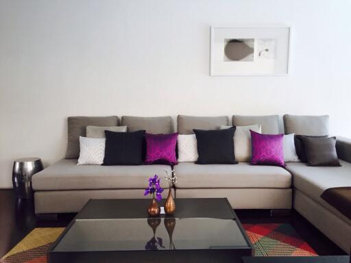 Modern living room with a sectional sofa and colorful decorative pillows