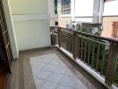 Spacious balcony with tiled flooring and railing