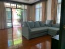 Spacious living room with large windows and sectional sofa