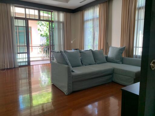 Spacious living room with large windows and sectional sofa