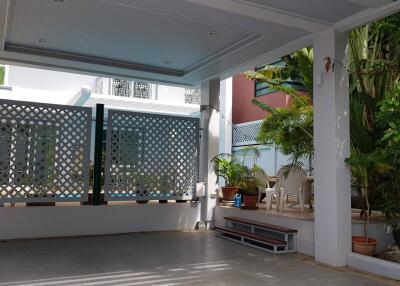 Covered outdoor area with plants and seating