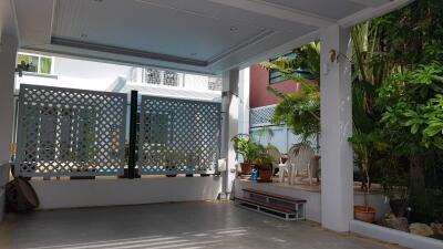 Covered outdoor area with plants and seating