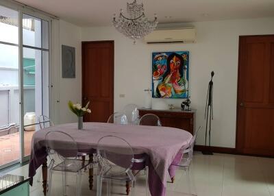 Dining room with a chandelier, air conditioner, and glass-paneled doors