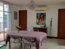 Dining room with a chandelier, air conditioner, and glass-paneled doors