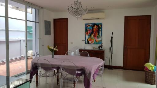 Dining room with a chandelier, air conditioner, and glass-paneled doors