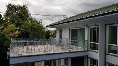 Exterior view of a two-story building with a balcony