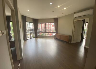 Spacious living room with large windows and balcony