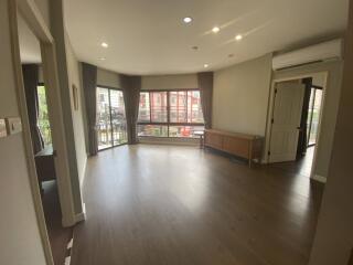 Spacious living room with large windows and balcony