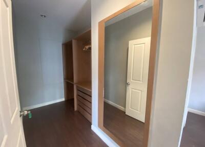 Walk-in closet with large mirror and wooden finishings