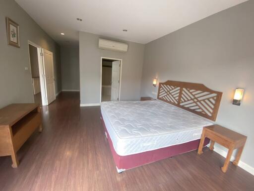 Spacious bedroom with double bed and wooden furniture